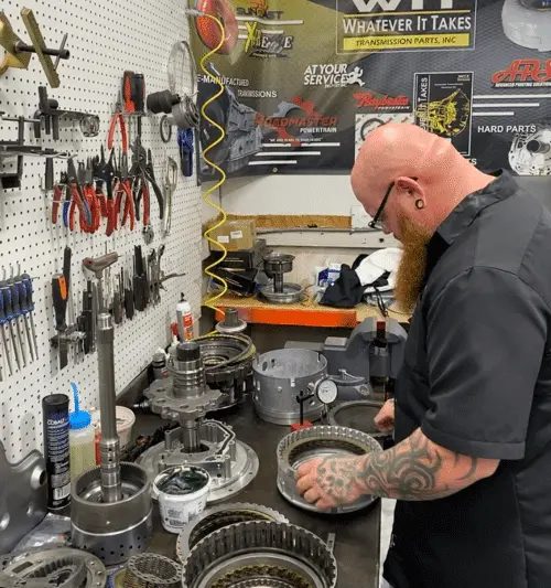 Diesel Truck Transmission Rebuild: Signs You Need Expert Help from Transmission Specialists Near You with RDI Power in Brooksville, FL. Image of transmission rebuild specialist mechanic working on transmission parts in the shop.