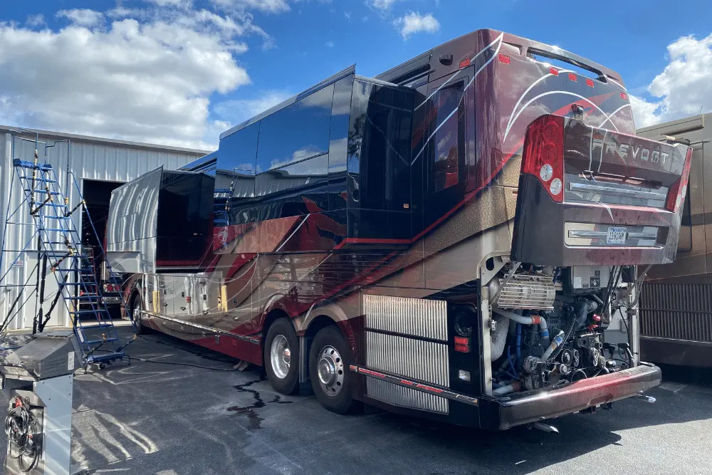 RV & Diesel Truck Maintenance in Brooksville, FL by RDI Power. Image of a Prevost motorhome with its engine compartment open while undergoing professional diagnostic and repair service at the shop.