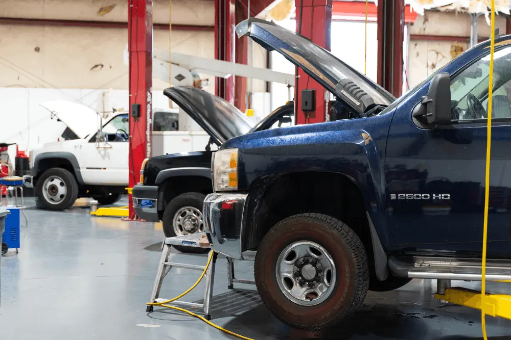 Diesel repair partner in Brooksville, FL at RDI Power. Image of Chevrolet heavy-duty pickup trucks with their hoods open inside the service shop for inspection and maintenance.