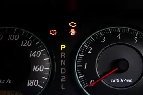 The warning lights of car engine check, door opened, parked and hand break in the speedometer of a vehicle