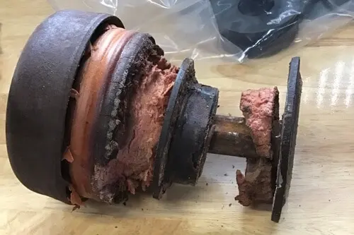 Does Your 2003 to 2016 Ford Have Bad Cab Mounts? with RDI Power in Brooksville, FL; closeup image of a faulty cab mount from truck in shop