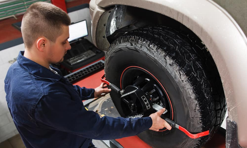 RDI Power auto technician works on a diesel truck’s wheel alignment