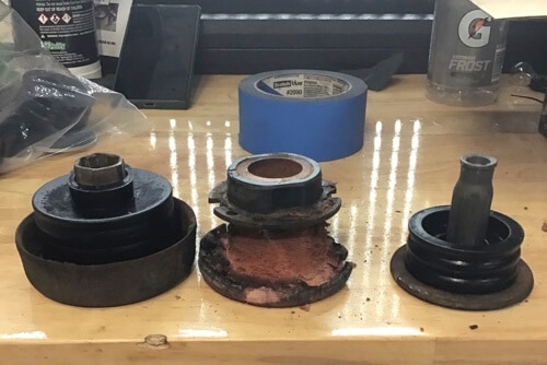 closeup image of brand new cab mounts and faulty cab mounts sitting side by side