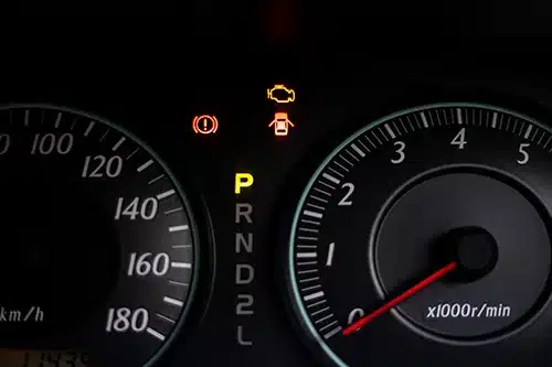 The warning lights of car engine check, door opened, parked and hand break in the speedometer of a vehicle
