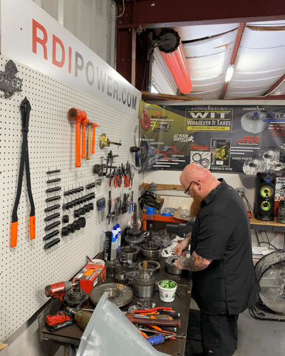 Transmission rebuild specialist at RDI power in the process of rebuilding a transmission for diesel truck in the shop.
